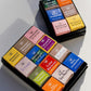 Assorted 100% dark chocolate tasting set with 12 single-origin chocolates from different cacao-growing regions