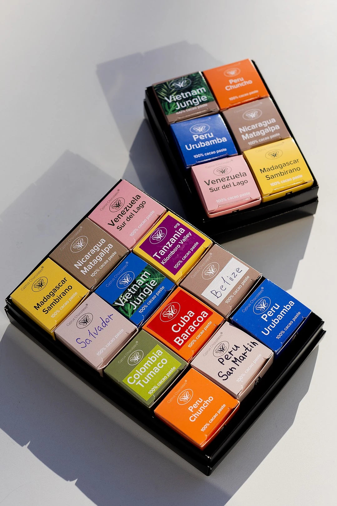 Assorted 100% dark chocolate tasting set with 12 single-origin chocolates from different cacao-growing regions