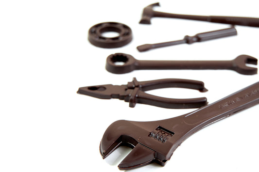 Chocolate tools set crafted from dark, milk, white, or ruby chocolate, shaped like realistic workshop tools and presented as a unique artisan chocolate gift